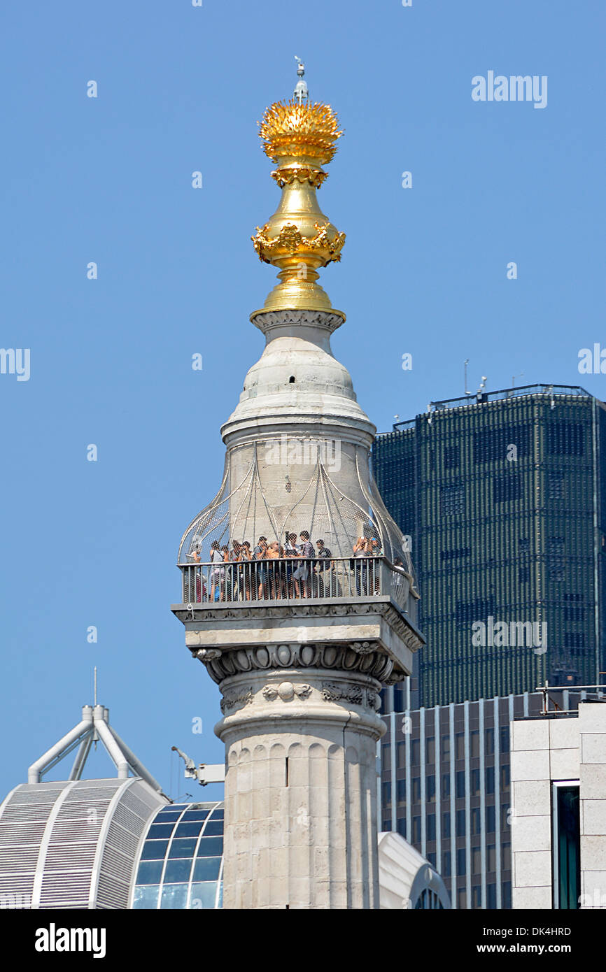 Tourists on the viewing platform at the top of the Monument column commemorating the Great Fire of London Stock Photo