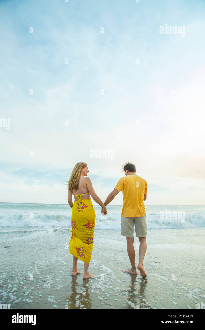 Couple holding hands beach behind hi-res stock photography and images ...