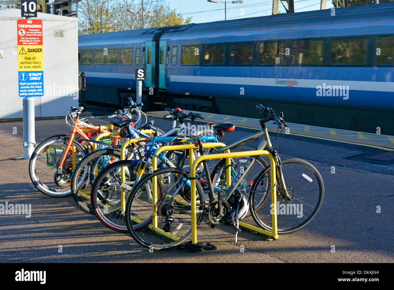 Cycle rack on platform at train station Stock Photo