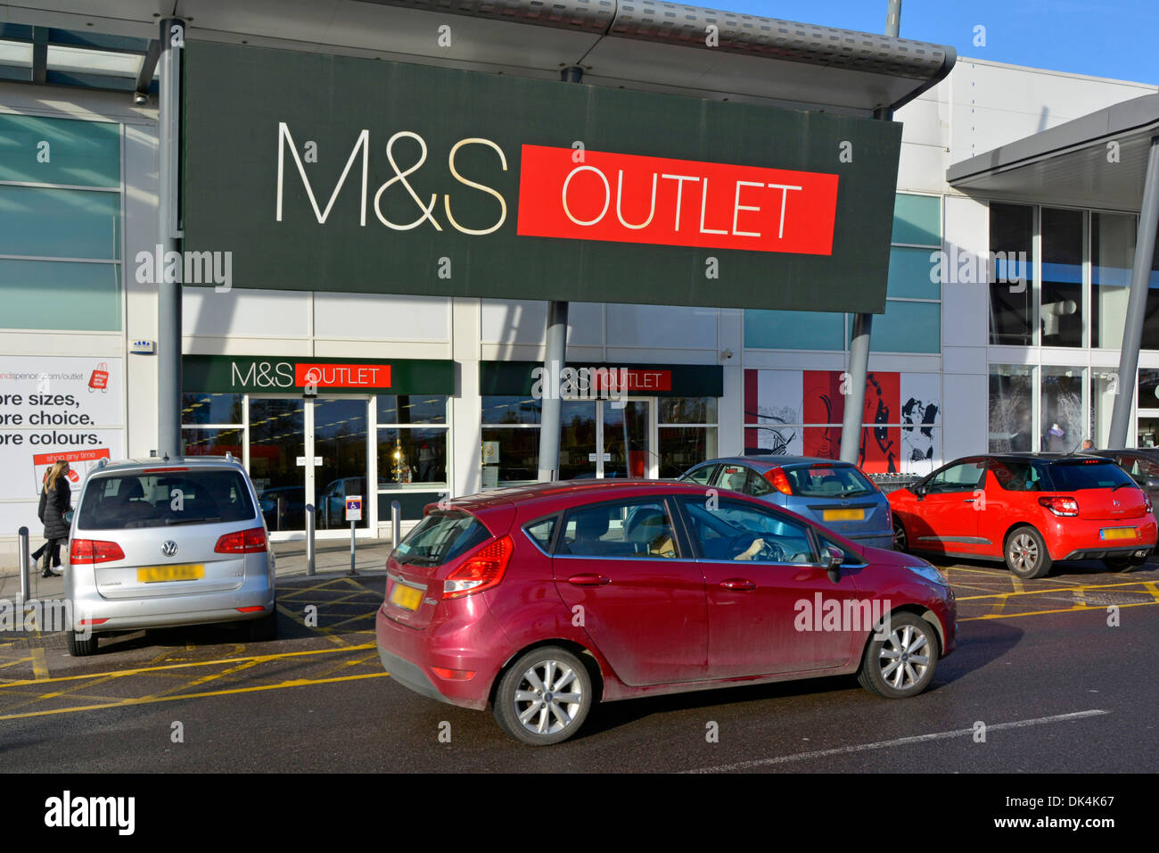 Motorist looking for parking space outside M&S outlet store in a retail park (obscured numerplates) Stock Photo