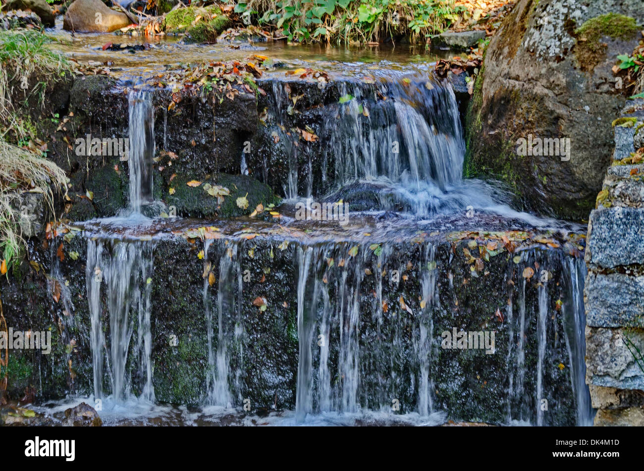 Beauty autumnal waterfall at small river in mountain Stock Photo