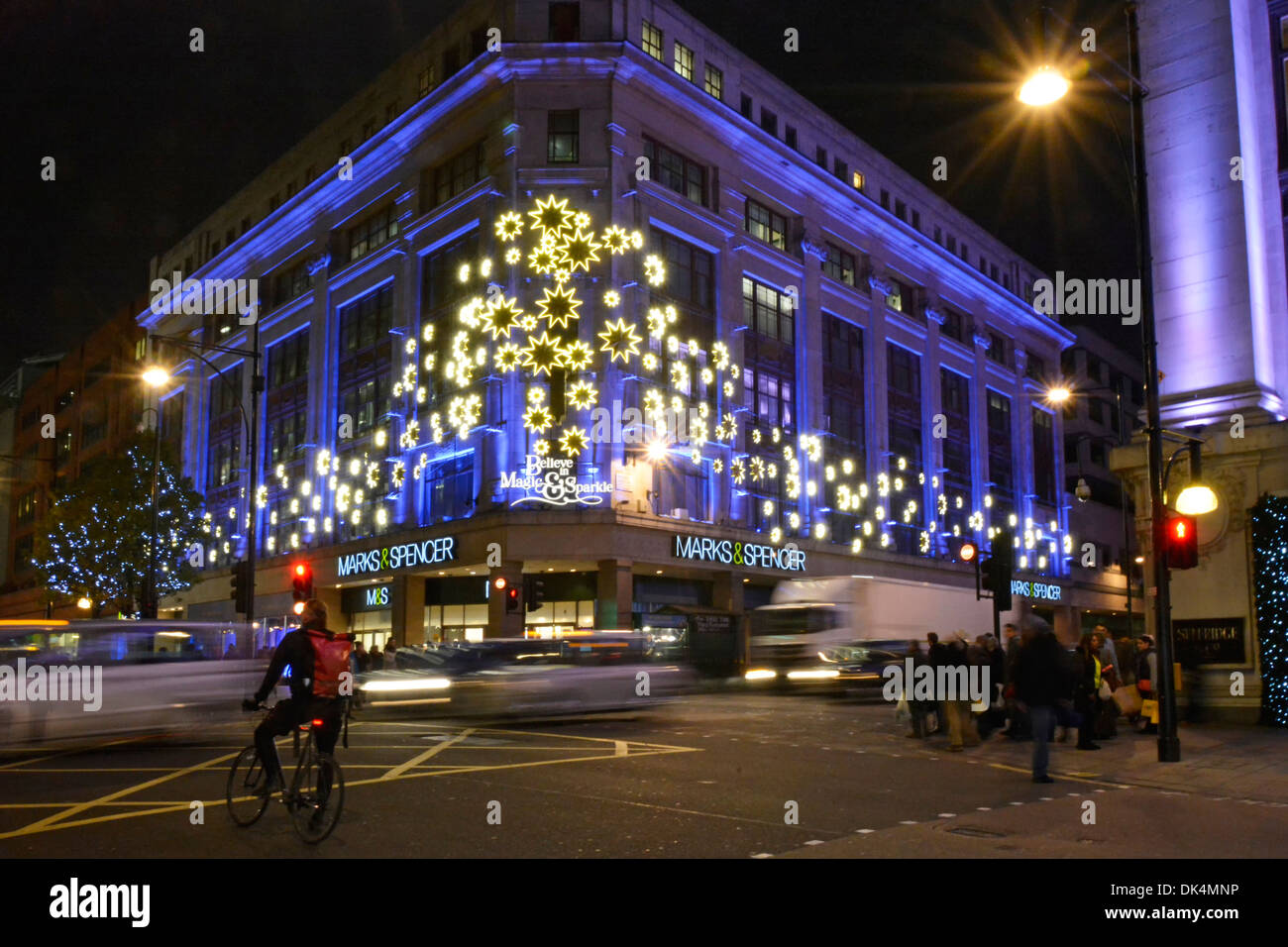 Christmas floodlights Xmas night lights Marks and Spencer store building corner of Oxford Street Baker Street M&S retail shopping business London UK Stock Photo