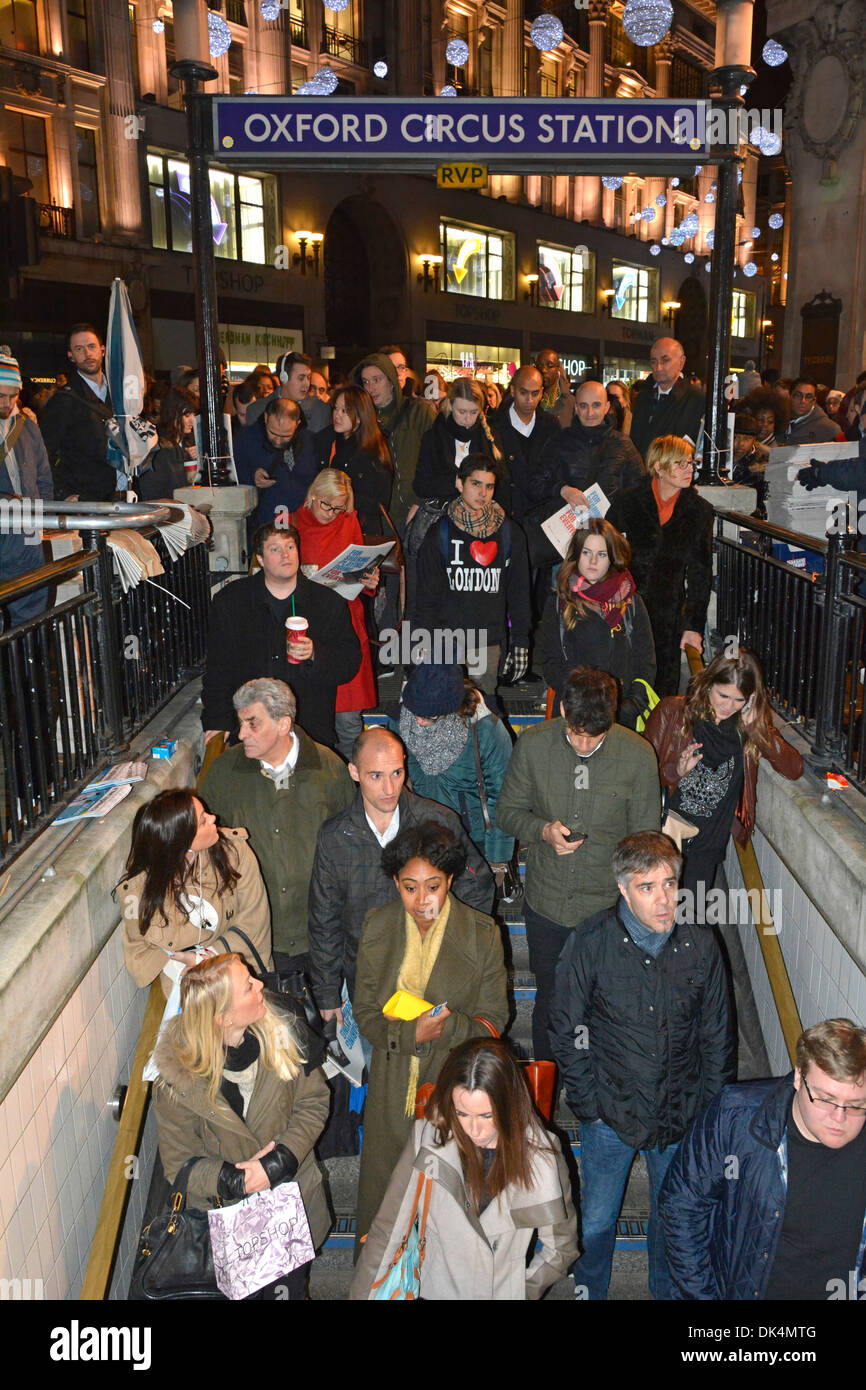 Commuters evening rush hour descending steps down to Oxford Circus Underground station Stock Photo
