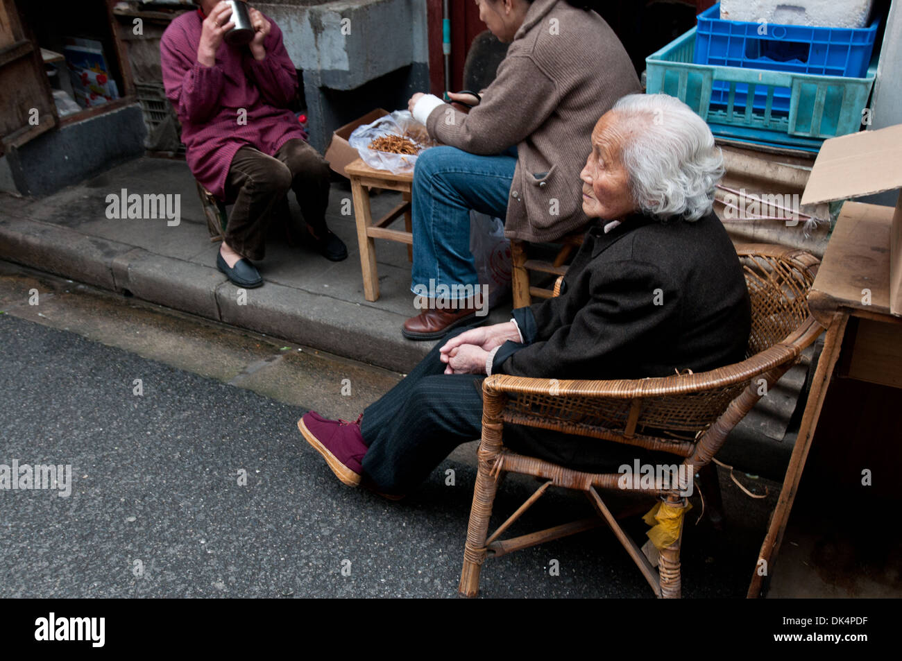 Old woman sitting in front of her house hi-res stock photography and ...