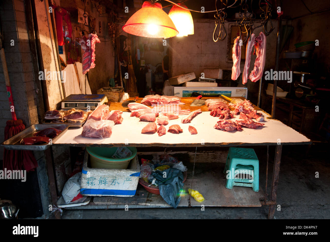 A Chinese butcher prepares meat in his shop in a village in China