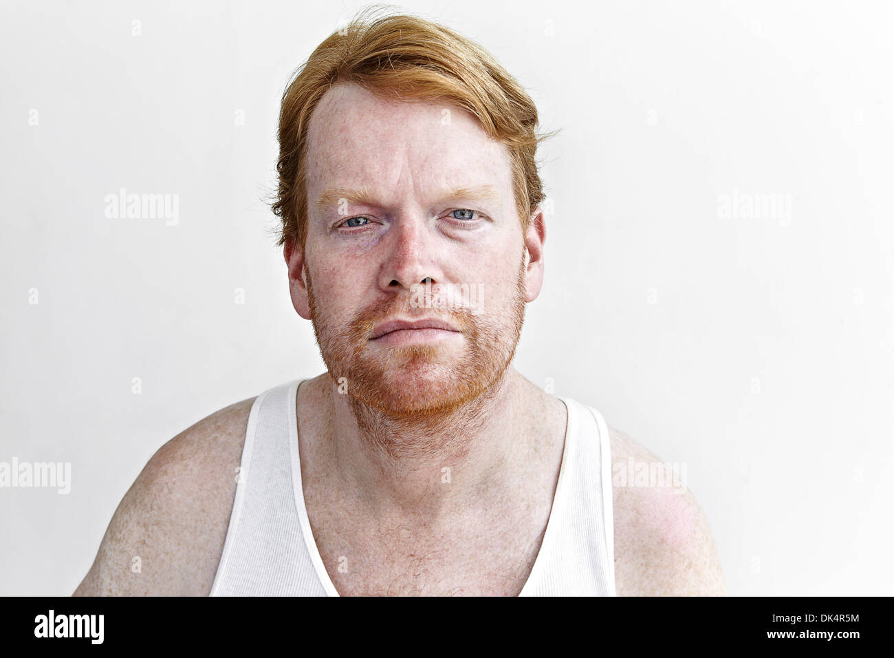 Portrait of man in white tank looking at camera Stock Photo