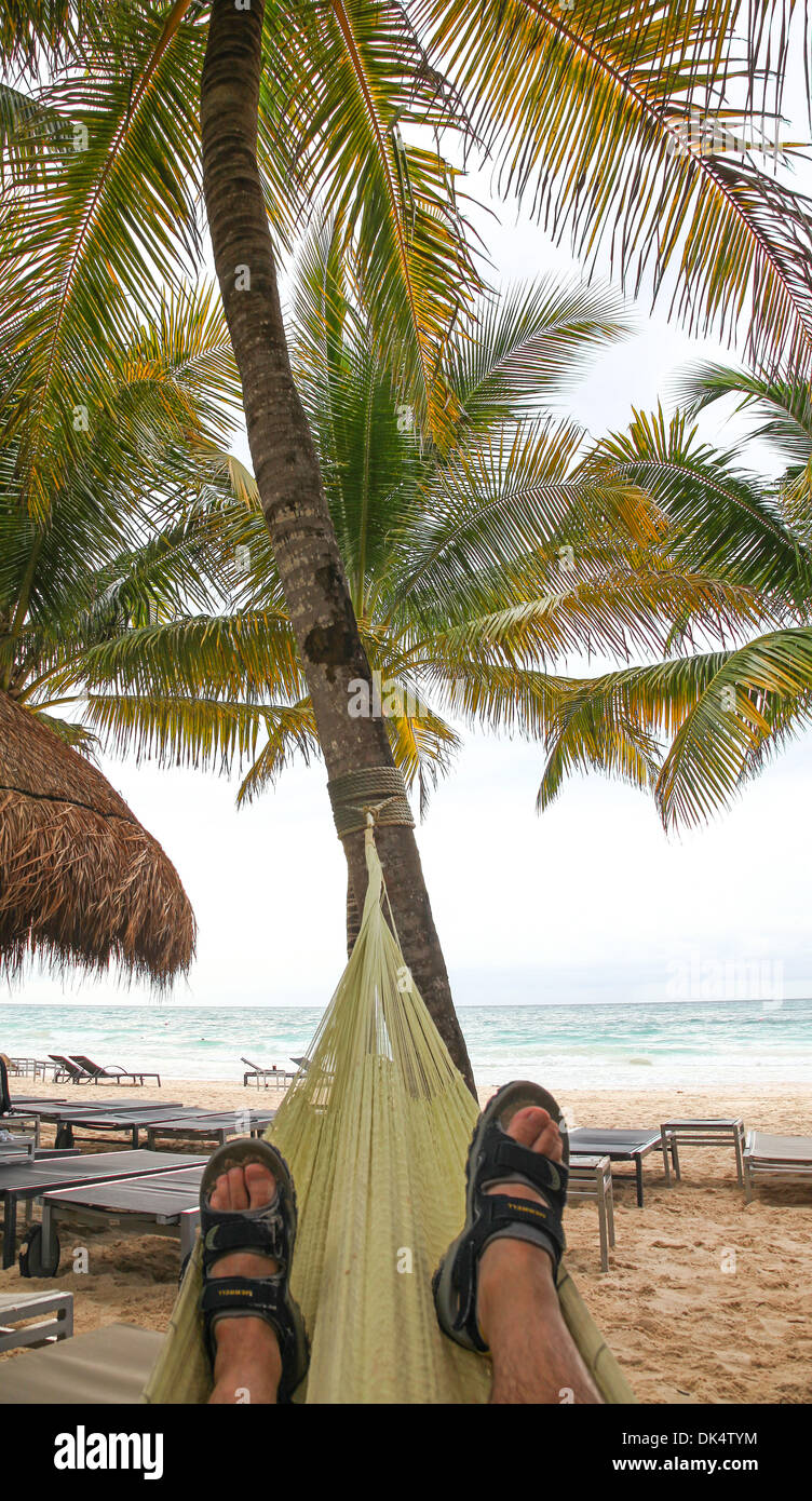 A man relaxing in a hammock on the beach at Riviera Maya Cancun Quintana Roo Yucatan Peninsular Mexico North America Stock Photo