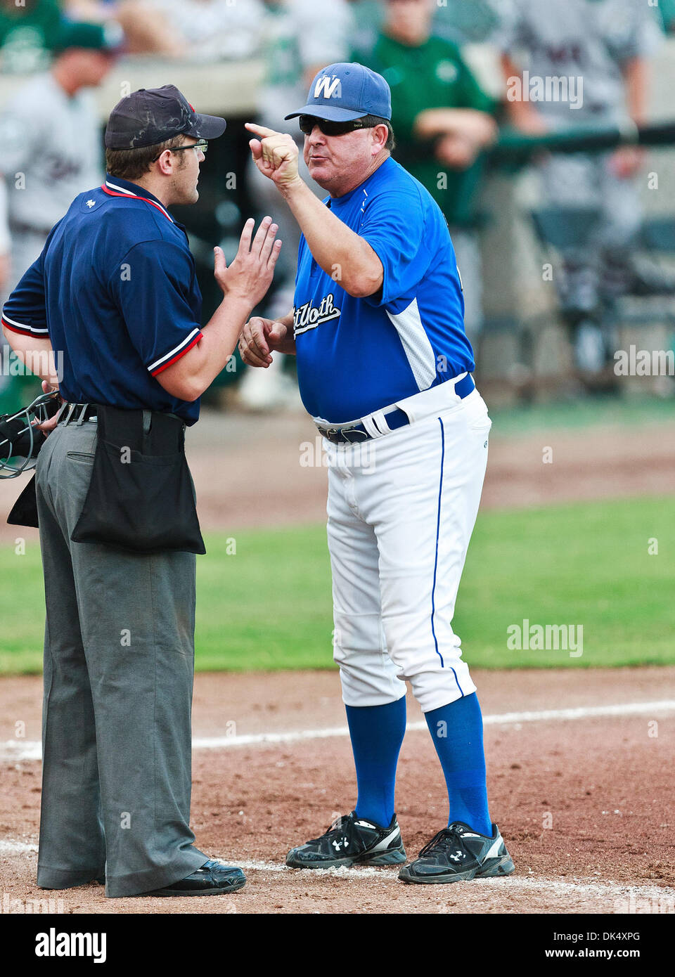 July 19, 2011 - Fort Worth, Texas, U.S - Fort Worth Cats Manager, Stan Hough, has a disagreement with home plate umpire, Shaylor Smith, during the American Association of Independant Professional Baseball game between the Gary Southshore Railcats and the Fort Worth Cats at the historic LaGrave Baseball Field in Fort Worth, Tx. Gary Southshore defeats Fort Worth 7 to 3. (Credit Imag Stock Photo