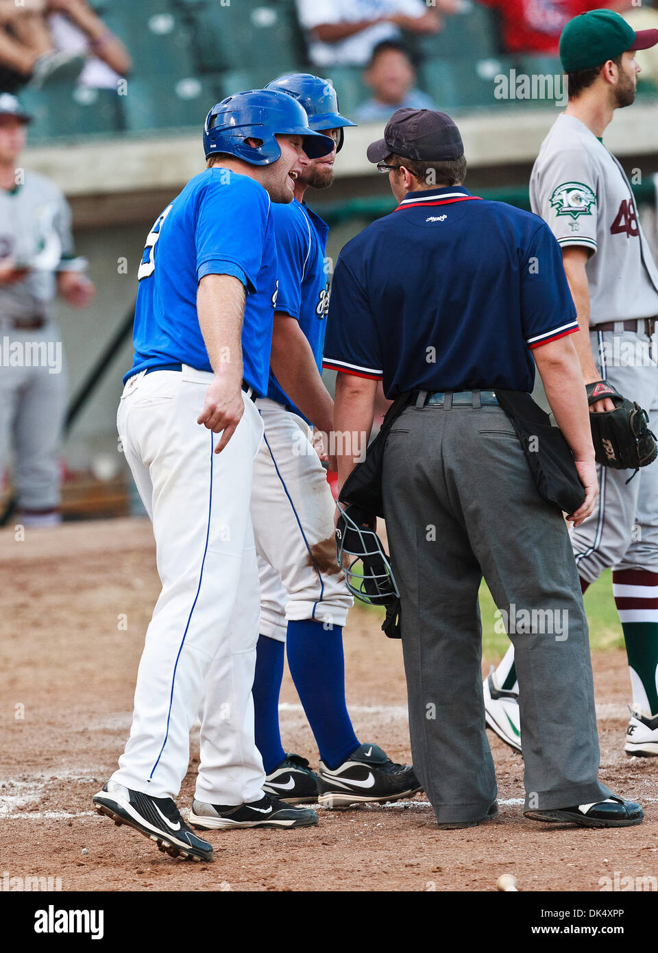 July 19, 2011 - Fort Worth, Texas, U.S - Fort Worth Cats Infielder Trent Lockwood (9) has a discussion with the home plate umpire, Shaylor Smith, during the American Association of Independant Professional Baseball game between the Gary Southshore Railcats and the Fort Worth Cats at the historic LaGrave Baseball Field in Fort Worth, Tx. Gary Southshore defeats Fort Worth 7 to 3. (C Stock Photo