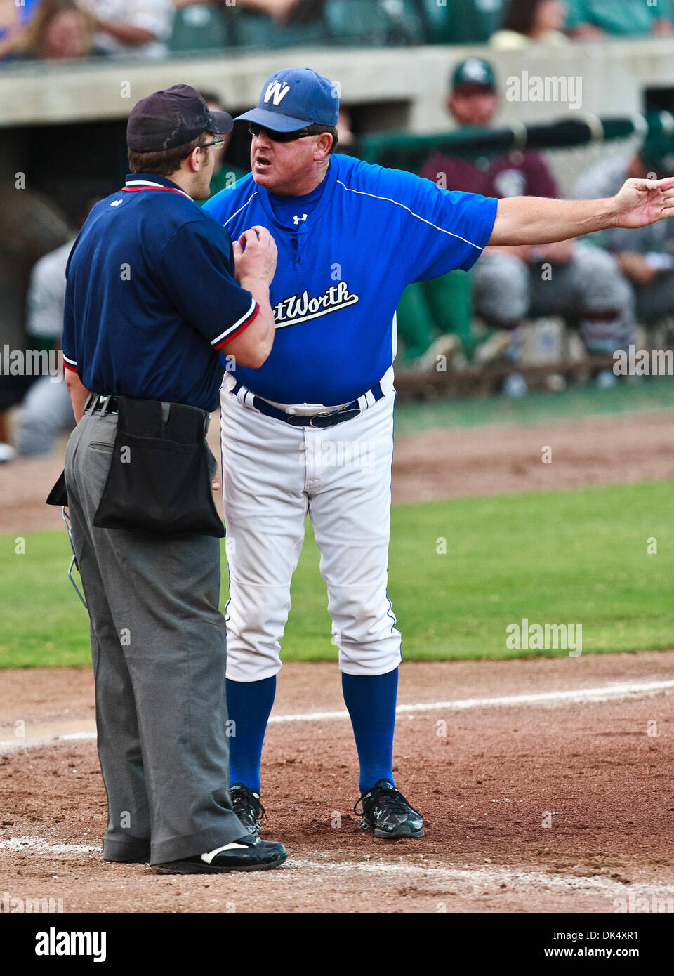 July 19, 2011 - Fort Worth, Texas, U.S - The Fort Worth Cats Manager, Stan Hough, shows his displeasure about a call with the home plate umpire, Shaylor Smith, during the American Association of Independant Professional Baseball game between the Gary Southshore Railcats and the Fort Worth Cats at the historic LaGrave Baseball Field in Fort Worth, Tx. Gary Southshore defeats Fort Wo Stock Photo