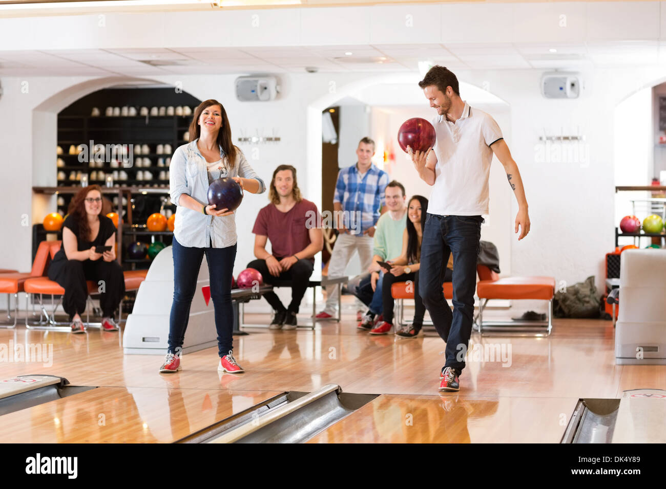 Man And Woman Holding Bowling Balls in Club Stock Photo Alamy