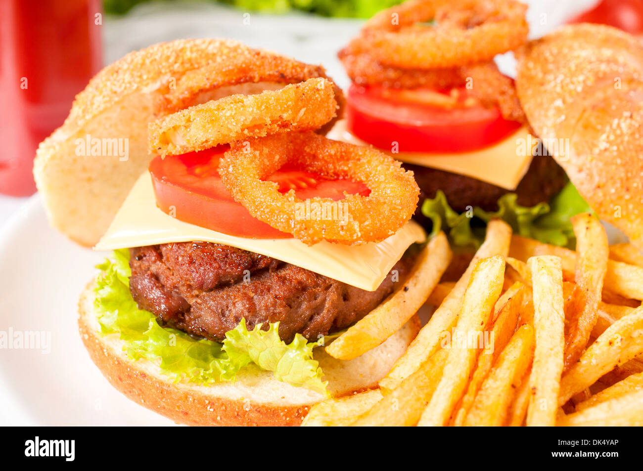 Cheeseburger and deep fried onion rings.Selective focus on the meat Stock Photo Alamy