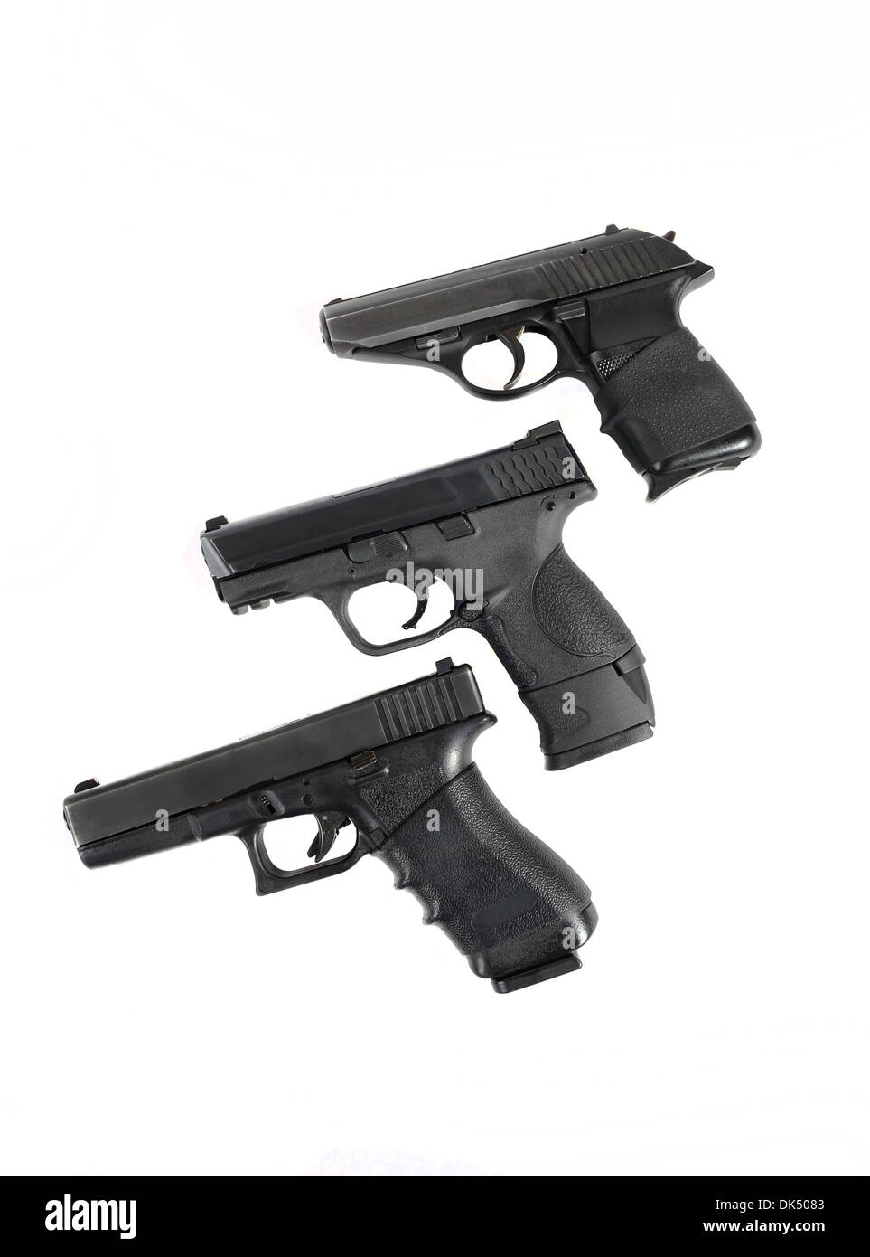 Three handguns in a row over white. No brands/makes markings. Stock Photo