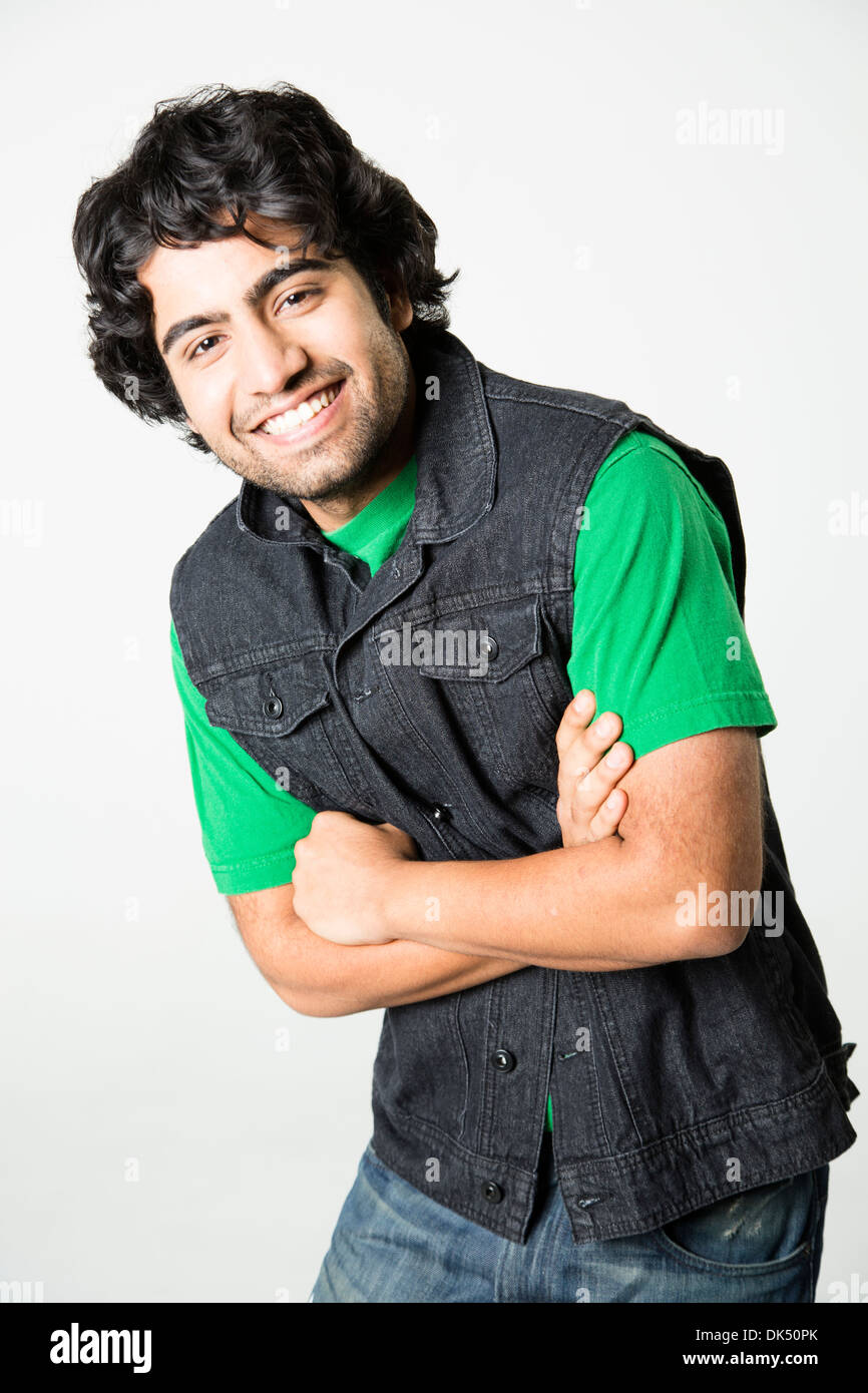 Smiling young Indian man with arms crossed Stock Photo - Alamy