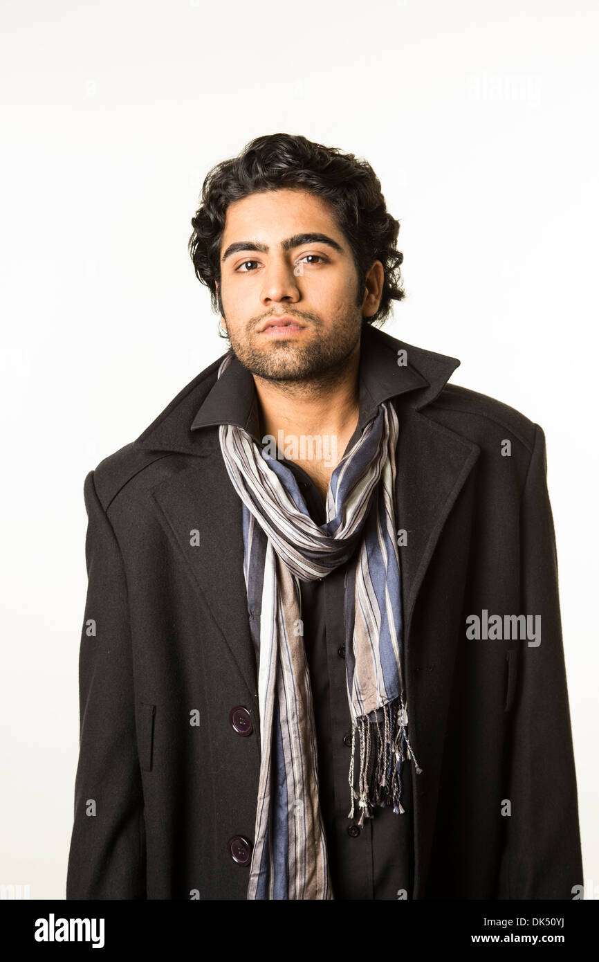 Young Indian man in a scarf and overcoat Stock Photo