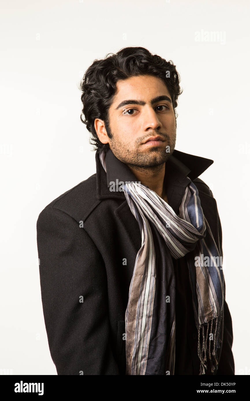Young Indian man in a scarf and overcoat Stock Photo