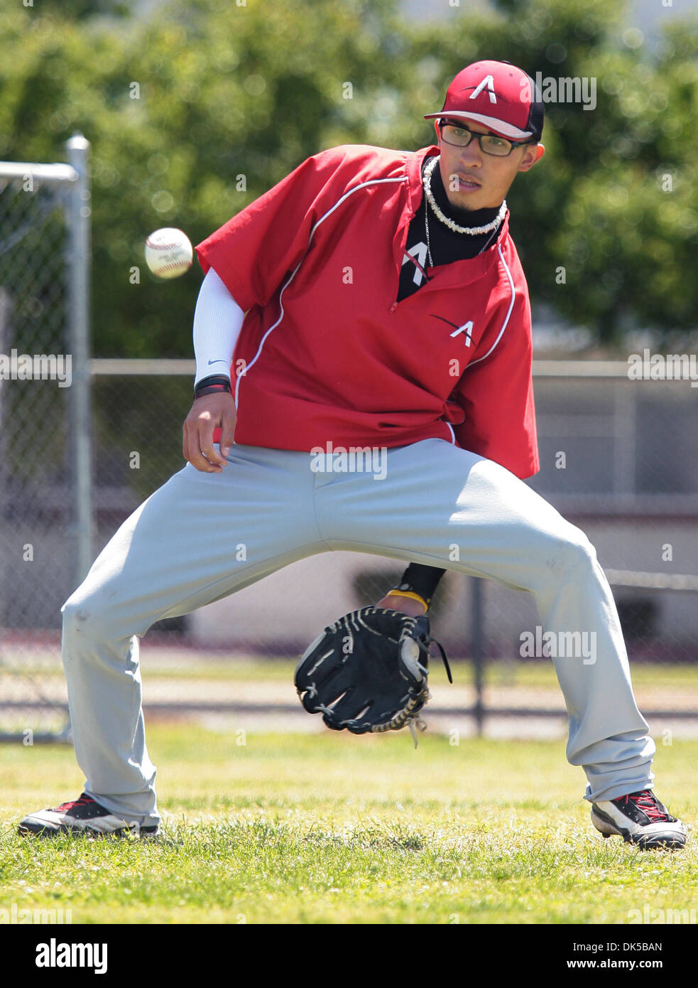 April 30, 2011 - Fresno, California, U.S. - JOHN WALKER/THE FRESNO BEE.Fernando Gutierrez makes a between-the-legs catch during agility drills during the Centeral Valley RBI (Reviving Baseball in Inner Cities) clinic Saturday, April 30, 2011, at Roosevelt High. Major League baseball created RBI as a way to draw more minorities into the sport. This more than just a baseball league.  Stock Photo