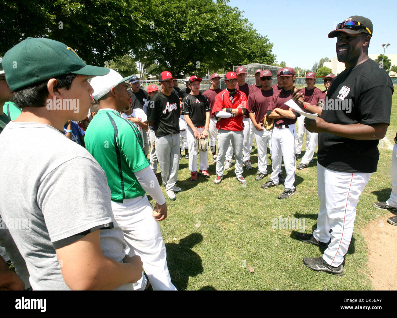 April 30, 2011 - Fresno, California, U.S. - JOHN WALKER/THE FRESNO BEE.Thomari Story-Harden talks with youths before taking the field for the Centeral Valley RBI (Reviving Baseball in Inner Cities) clinic Saturday, April 30, 2011, at Roosevelt High. Major League baseball created RBI as a way to draw more minorities into the sport. This more than just a baseball league. It's designe Stock Photo