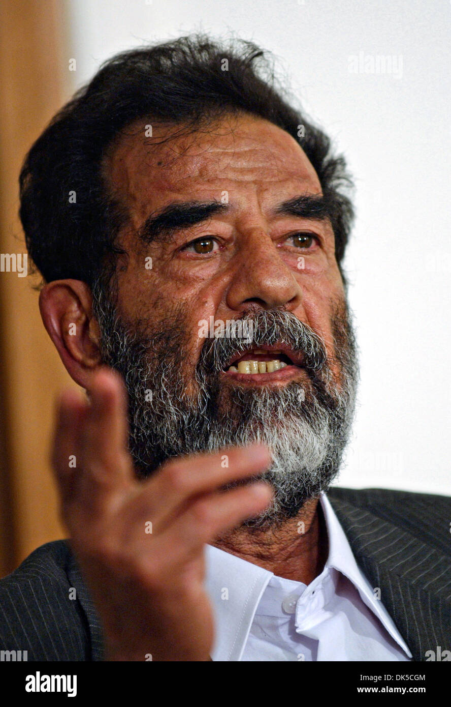 Former President of Iraq, Saddam Hussein gestures during his initial interview by a special tribunal after being captured July 2004 in Baghdad, Iraq. Stock Photo