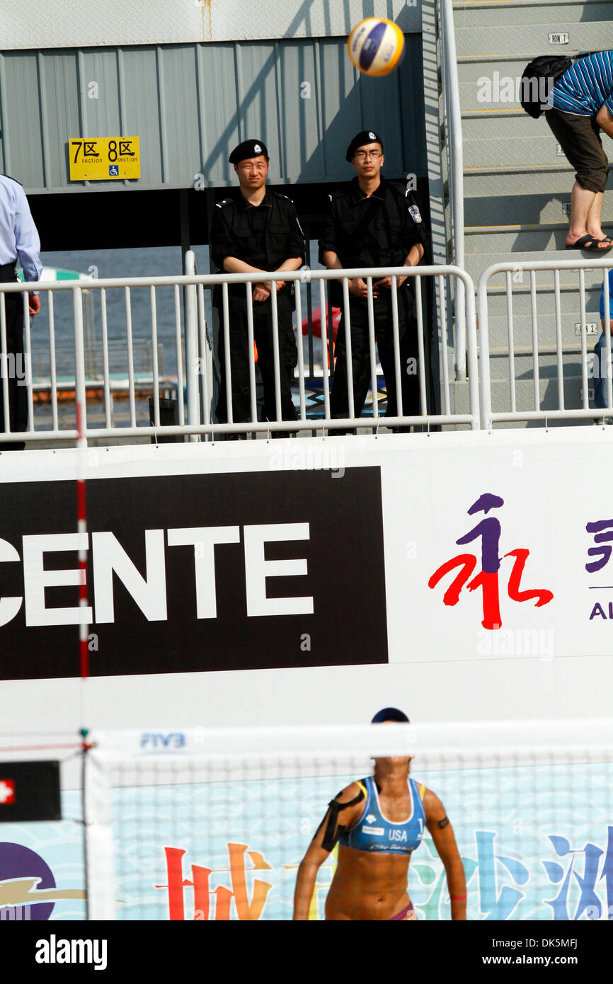 May 08, 2011 - Jinshan, China - Special police officers keep a watch over the crowd during the women's beach volleyball final at the SWATCH FIVB World Tour Shanghai Open. For Keizer and Van Iersel of the Netherlands it was the first FIVB World Tour title. The Dutch pair held on to win in three sets 15-21, 26-24, 15-13. Keizer and Van Iersel finished the Shanghai Open undefeated at  Stock Photo