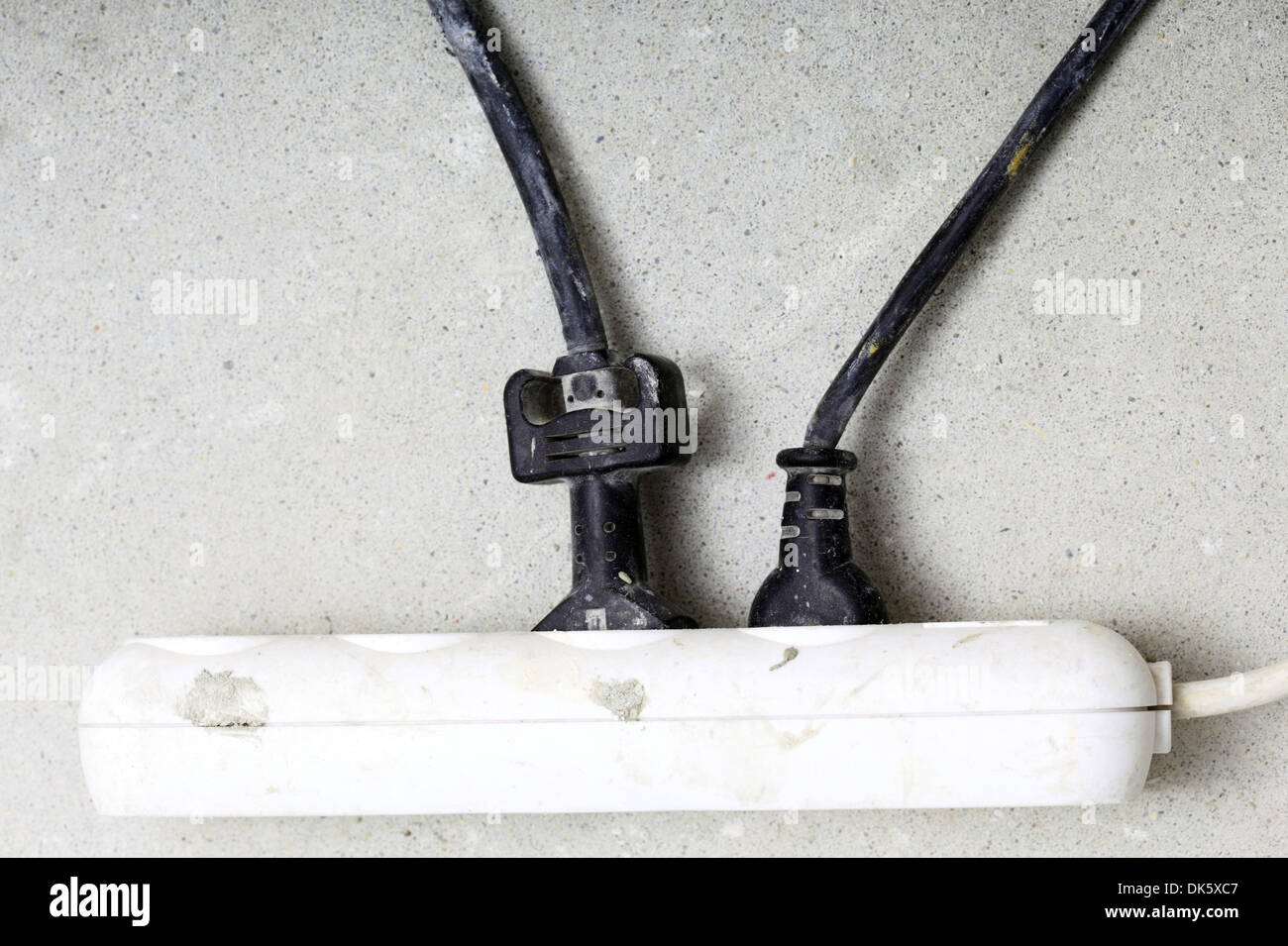 electrical cords connected to a power strip or extension block in