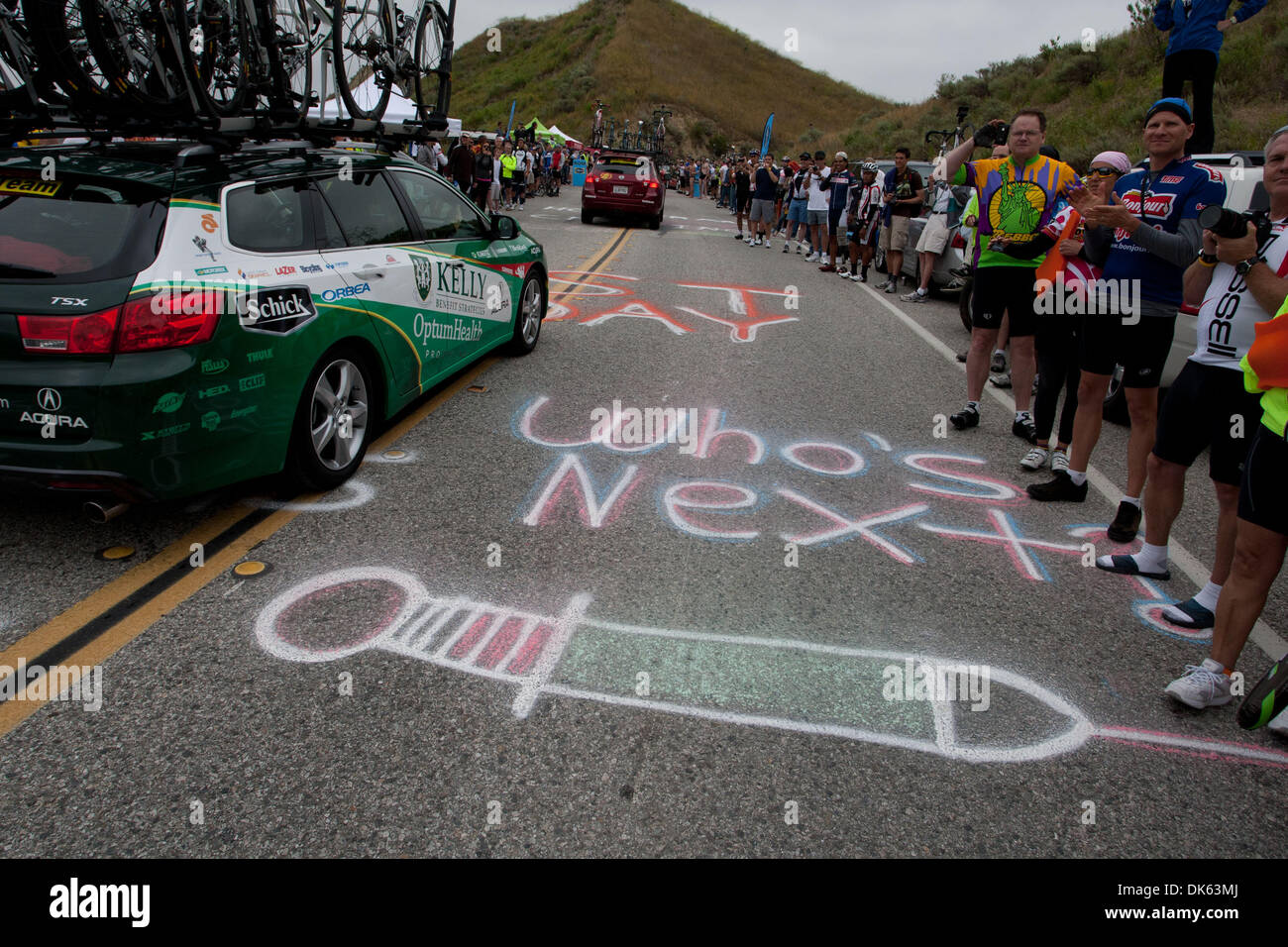 May 22, 2011 - Thousand Oaks, California, U.S. - Team cars pass over a painted syringe along the climb up Balcom Caynon during stage 8 of the Amgen Tour of California, a reference to allegations of performance-enhancing drug use among top cyclists. (Credit Image: © Wil Matthews/ZUMAPRESS.com) Stock Photo