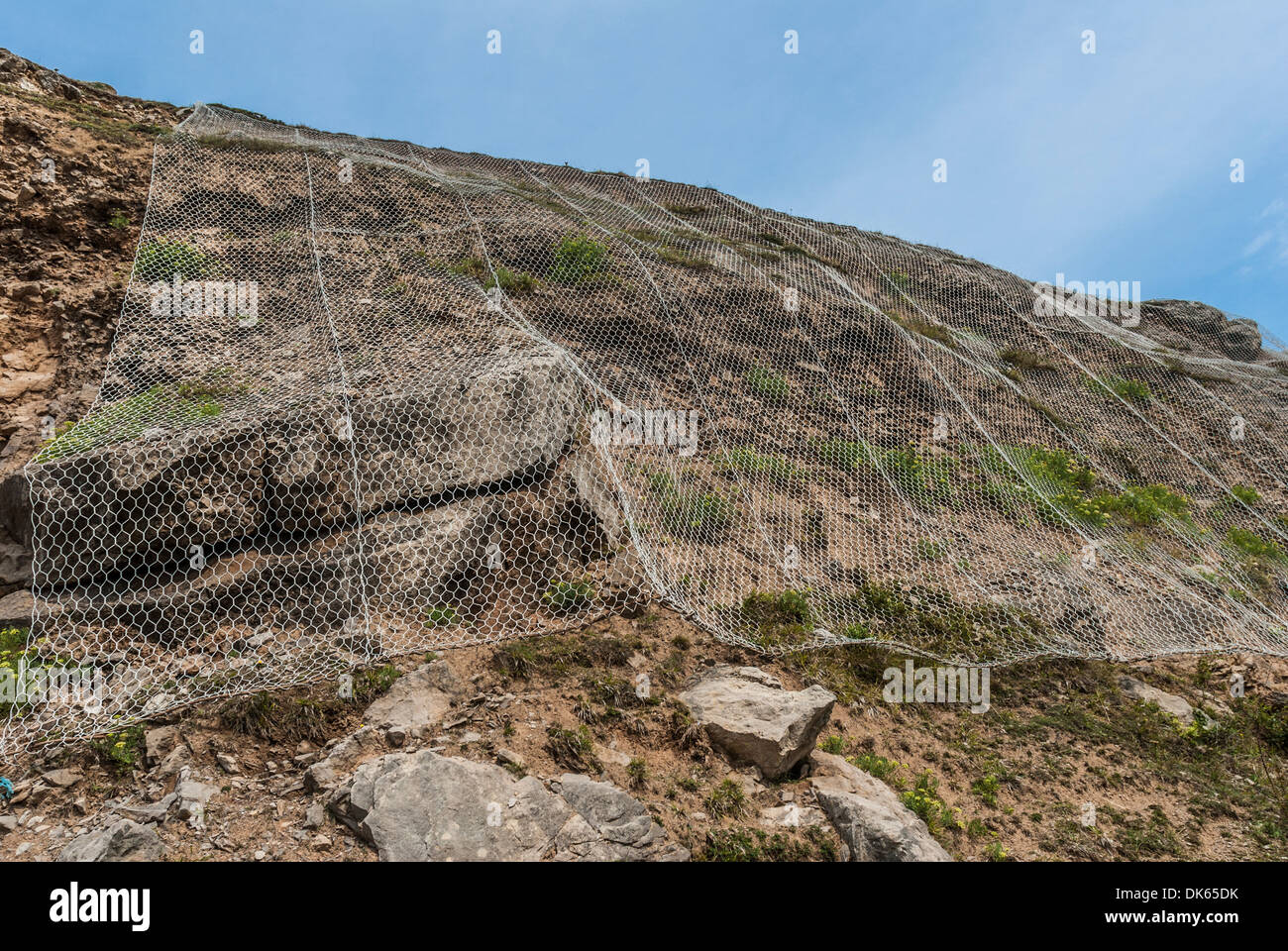 Wire netting creating a Gabon to stop rock falling Stock Photo - Alamy