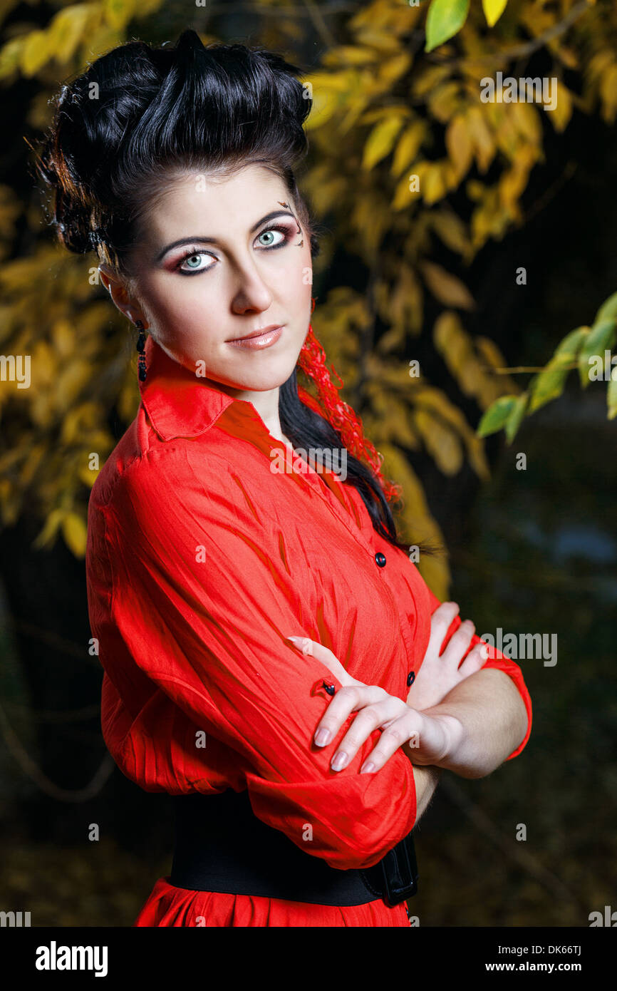 Young attractive girl in red shirt and with makeup closeup portrait in