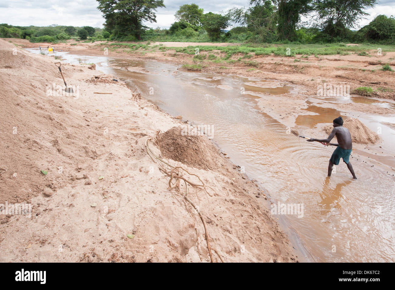 A Man Digs In The River Bed Of A River In Kenya To Harvest Sand Sand Harvesting Is A Solid Source Of Income For Farmers Stock Photo Alamy