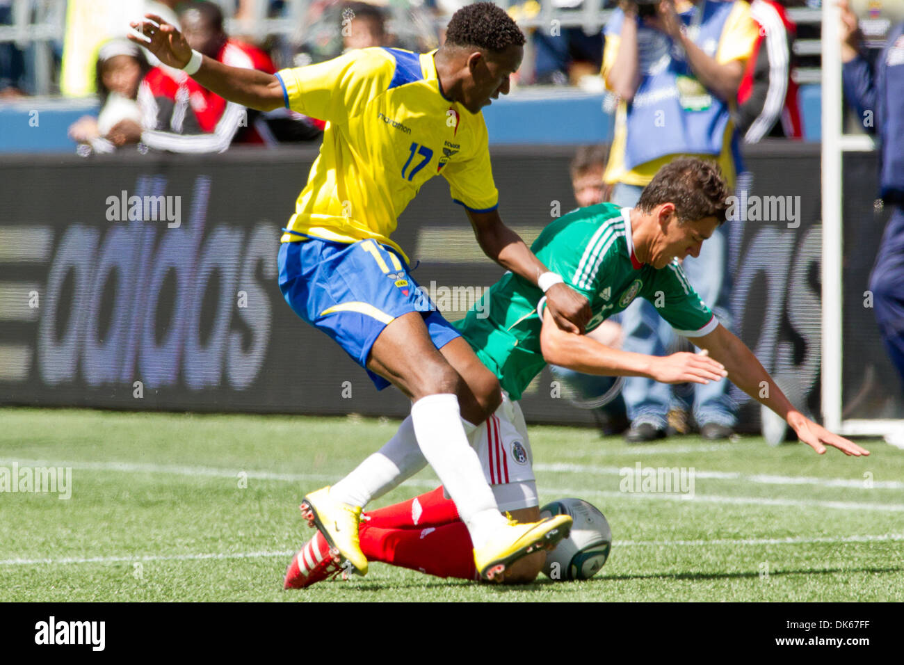 May 28, 2011 - Seattle, Washington, U.S - Mexico defender Hector Moreno (15) falls in front of Ecuador forward Jaime Ayovi (17) at Qwest Field in Seattle, Washington. The game ended in a 1-1 tie. (Credit Image: © Chris Hunt/Southcreek Global/ZUMApress.com) Stock Photo