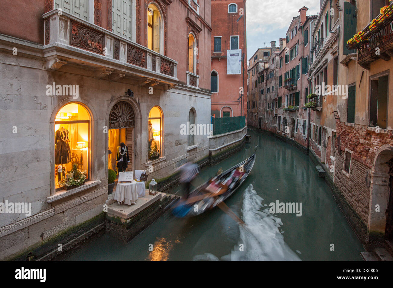 Gondola passes through a channel in Venice, at sunset Stock Photo - Alamy