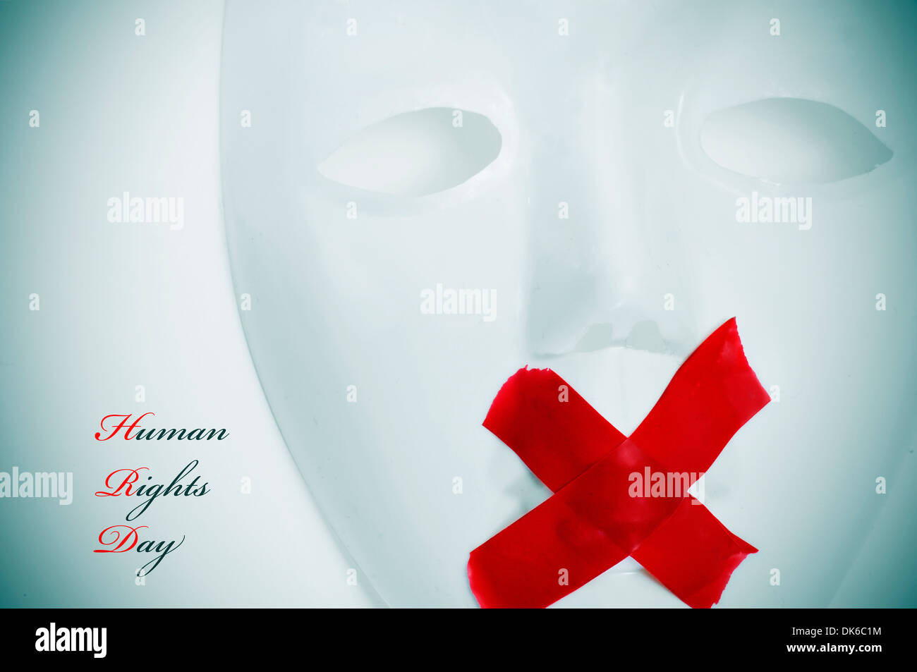 a white mask with its mouth shut with red tape and the text human rights day Stock Photo
