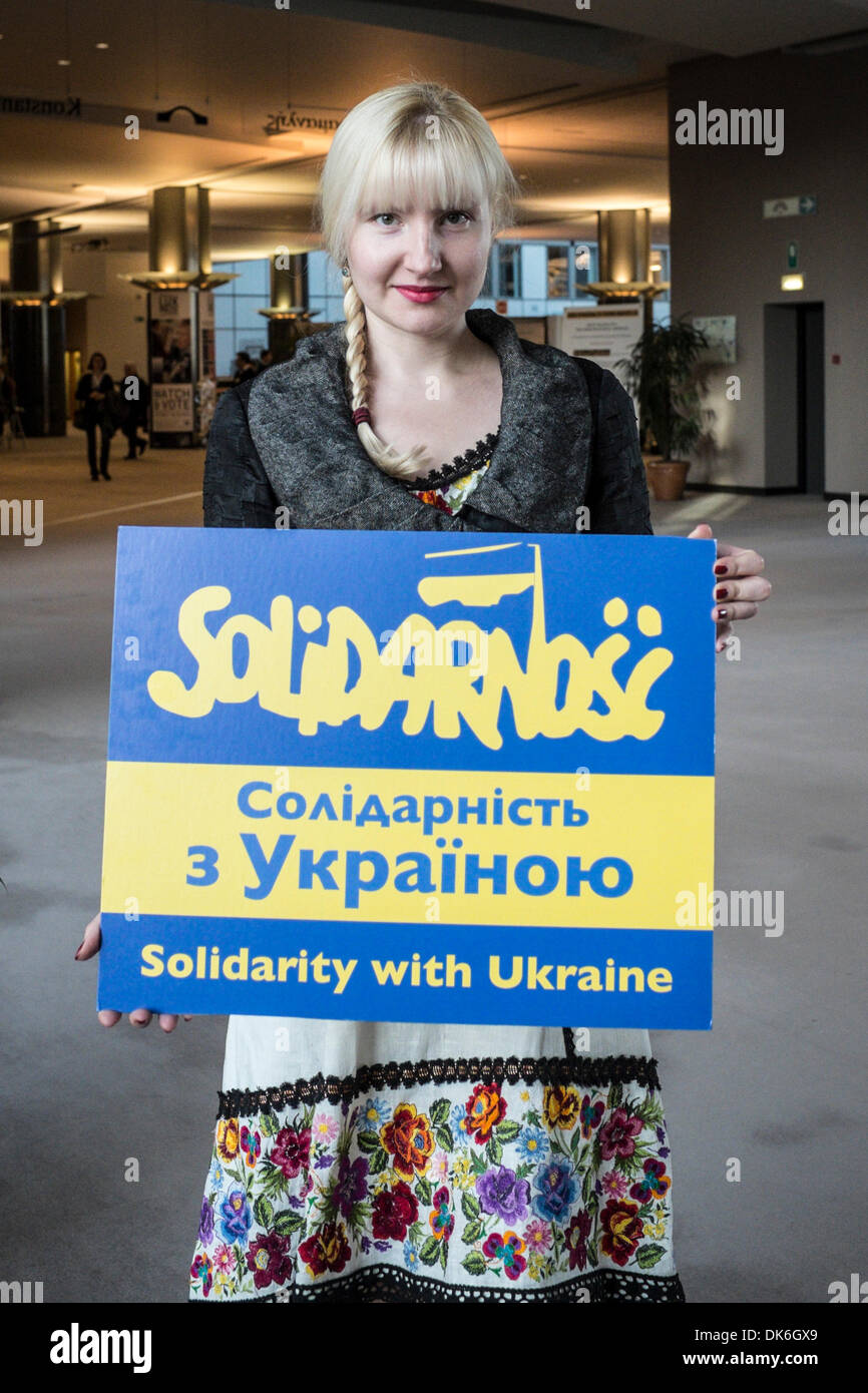 Ukrainian girl invites to participate in the action 'Solidarity with Ukraine' at European Parliament headquarters in Brussels, Belgium on 03.12.2013 by Wiktor Dabkowski Stock Photo