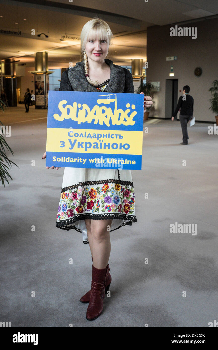Ukrainian girl invites to participate in the action 'Solidarity with Ukraine' at European Parliament headquarters in Brussels, Belgium on 03.12.2013 by Wiktor Dabkowski Stock Photo