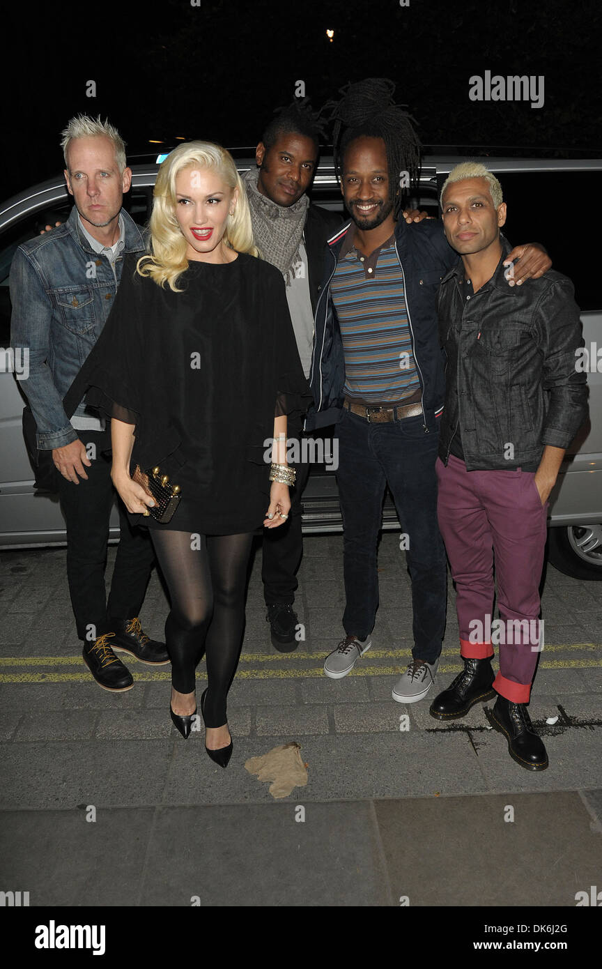 Gwen Stefani Dressed In A Short Top And Black Tights With Band Members