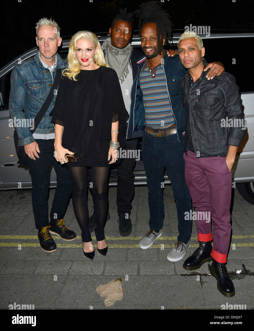 Gwen Stefani Dressed In A Short Top And Black Tights With Band Members