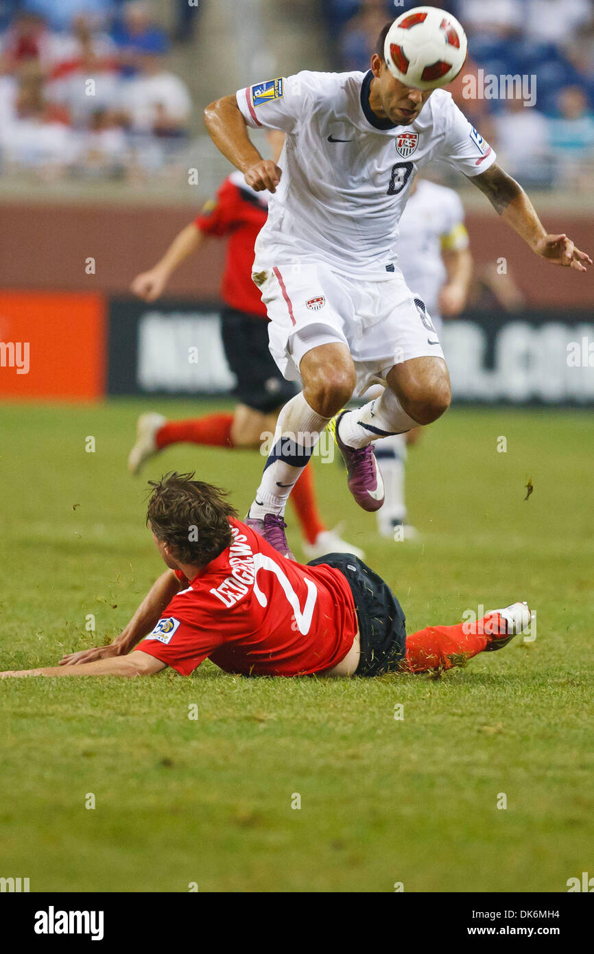 June 7, 2011 - Detroit, Michigan, U.S - United State midfielder Clint Dempsey (#8) heads the ball while leaping over Canada midfielder Nikolas Ledgerwood (#2) during second-half match action.  The United States defeated Canada 2-0 in the second match of the Group C-play opening round doubleheader of the 2011 CONCACAF Gold Cup soccer tournament played at Ford Field in Detroit, Michi Stock Photo