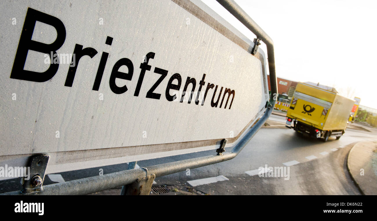 Pattensen, Germany. 03rd Dec, 2013. A truck of German courier company Deutsche Post AG drives past a sign which reads 'mail center' in Pattensen, Germany, 03 December 2013. Deutsche Post will raise the postage for regular letters (up to 20 g) to 0.60 Euro in 2014. Photo: JULIAN STRATENSCHULTE/dpa/Alamy Live News Stock Photo