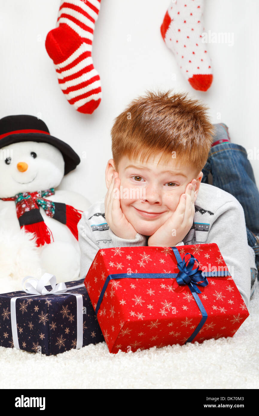 Happy smiling little boy with Christmas gift boxes Stock Photo - Alamy