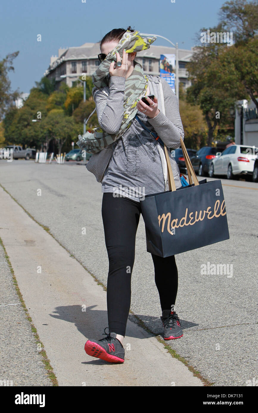 Michelle Trachtenberg hides her face from photographers while leaving
