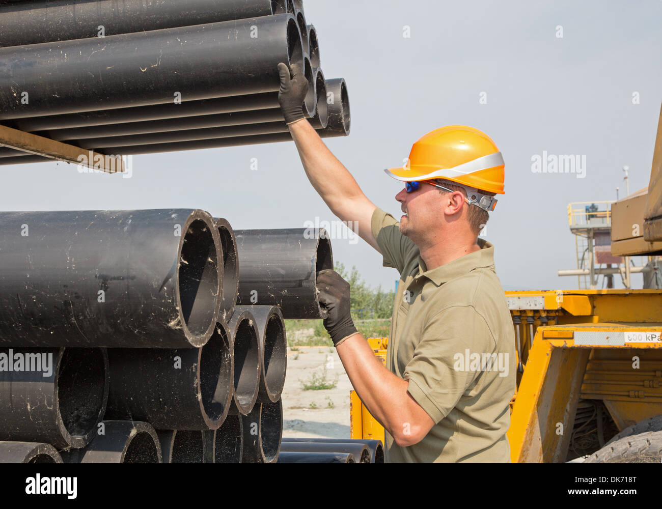 young worker and plastic pipes Stock Photo Alamy