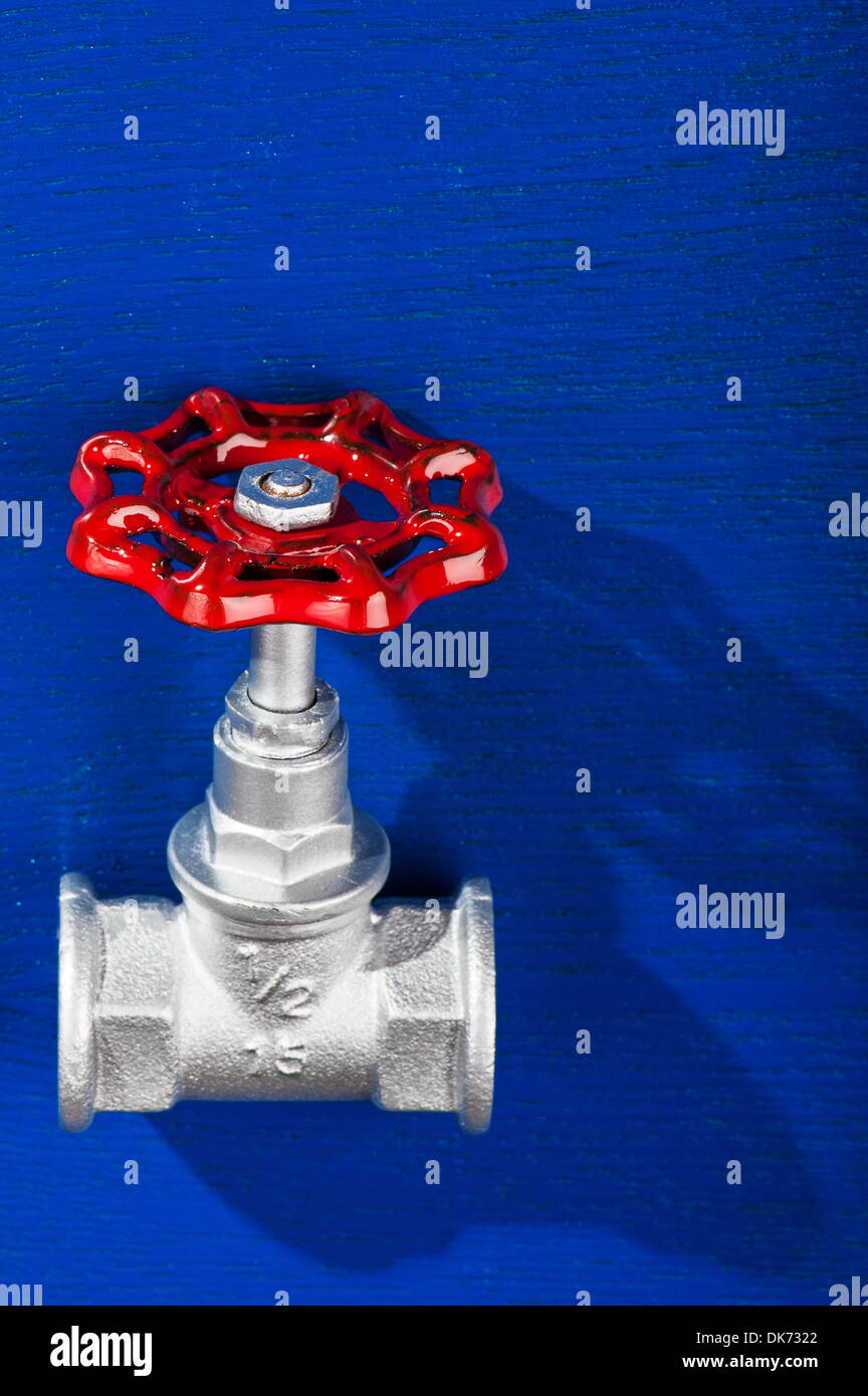 chrome brass valve - on blue background Stock Photo