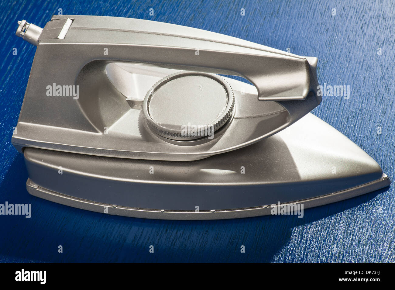 plastic electric iron on blue background Stock Photo Alamy