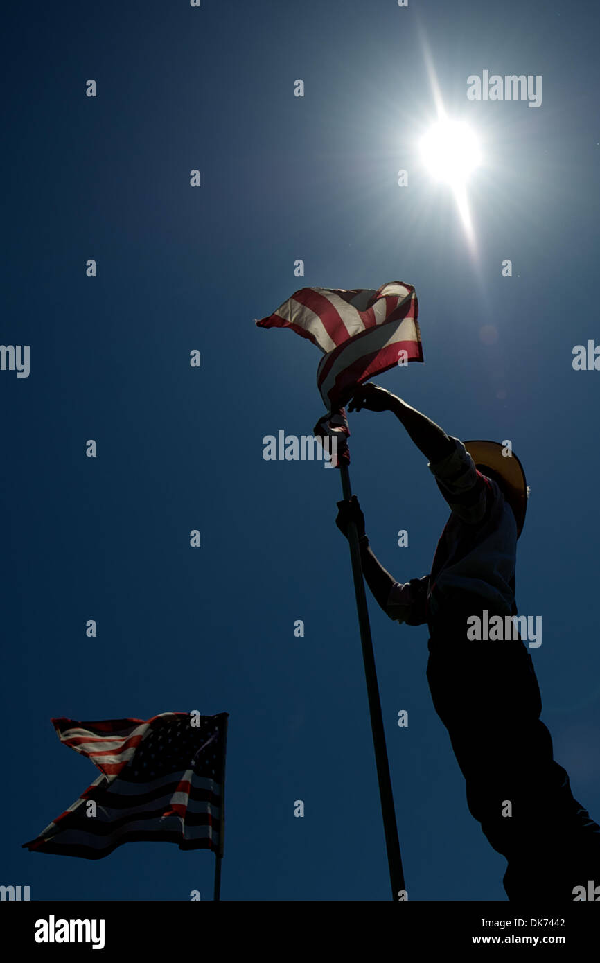 June 12, 2011 - Livermore, California, U.S - An arena worker unfurls an American flag at the 93rd Annual Livermore Rodeo at Robertson Park in Livermore, CA. (Credit Image: © Matt Cohen/Southcreek Global/ZUMAPRESS.com) Stock Photo