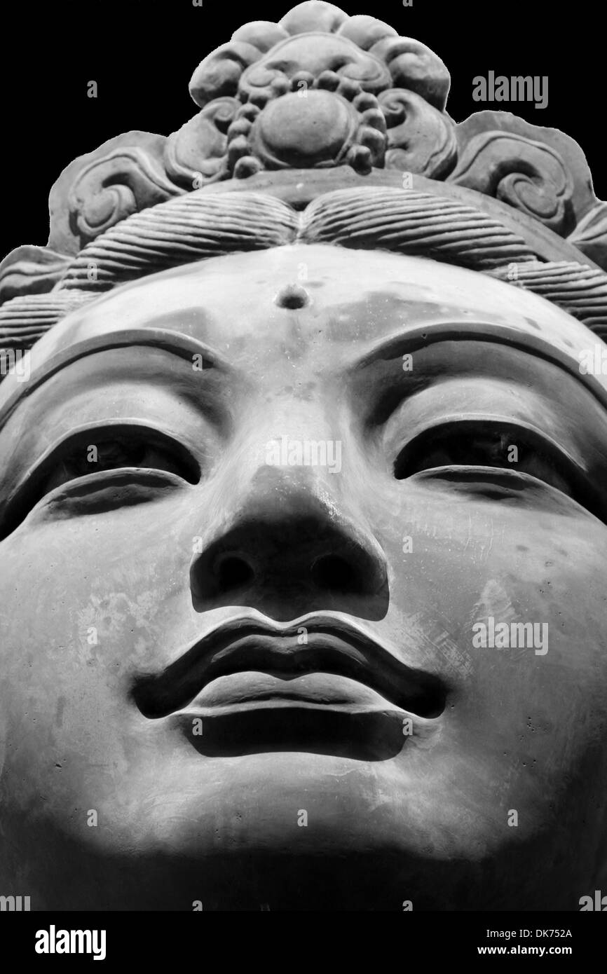 Black & White close up of one of the six 'The Offering of Six Devas' statues, surrounding the Tian Tan Big Buddha, Hong Kong. Stock Photo
