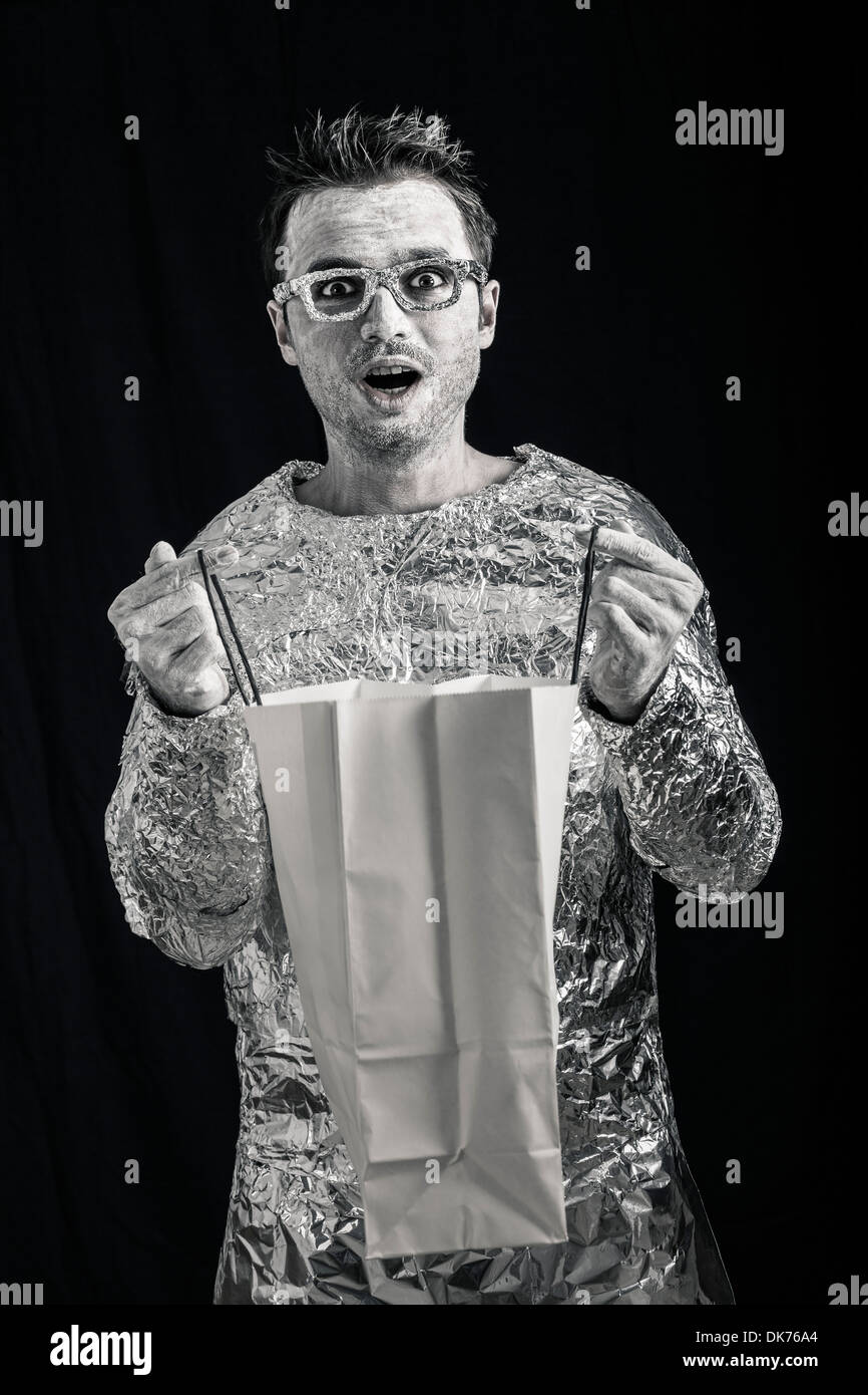 Shocked alien man holding shopping bag. Stock Photo