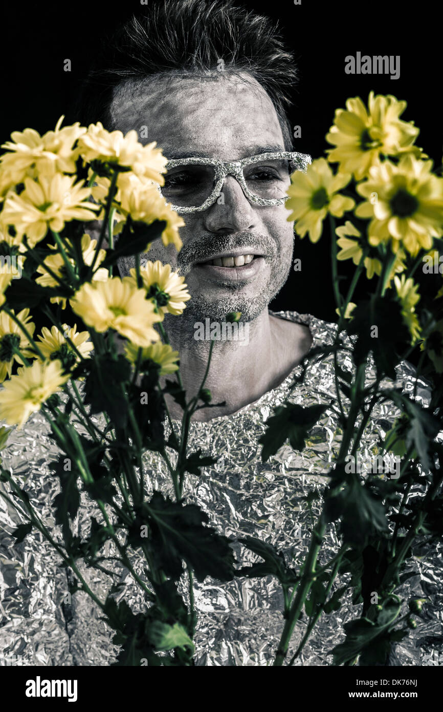 Closeup of happy spaceman looking at flowers. Stock Photo