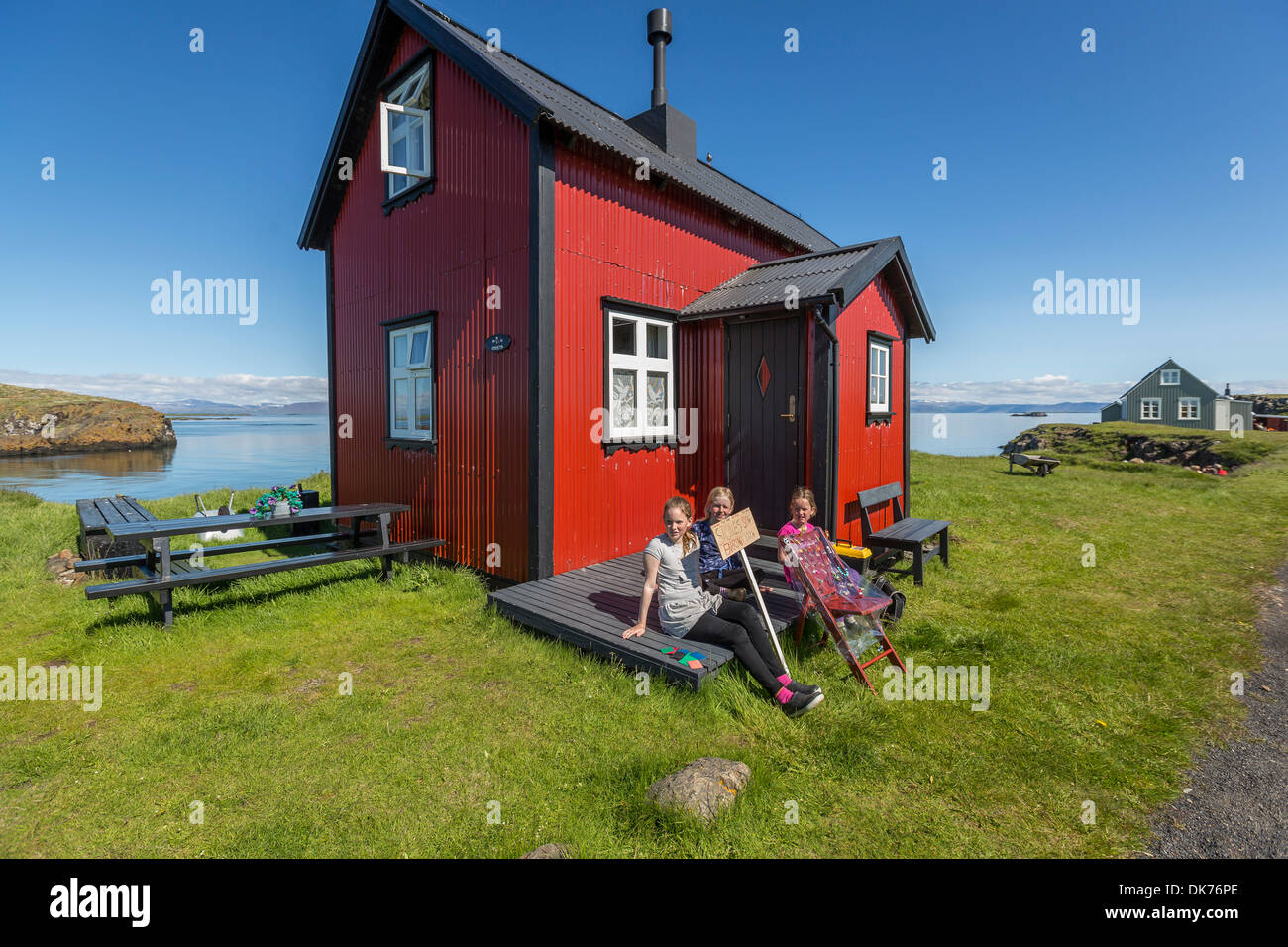 Young girls selling hand crafts to tourist. Flatey Island, Breidafjordur, Iceland Stock Photo