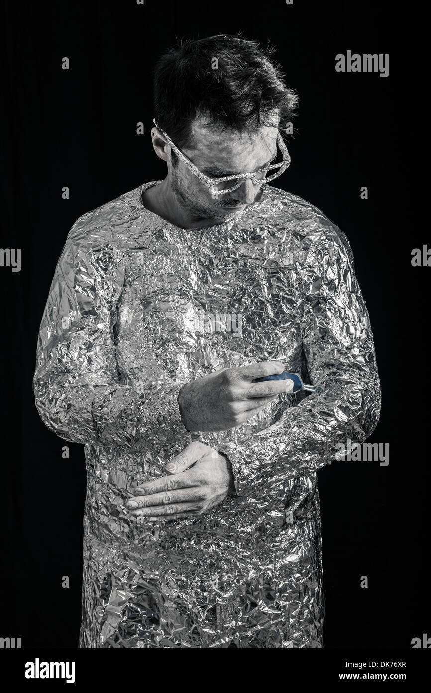 Portrait of cyborg man fixing himself with screwdriver. Stock Photo