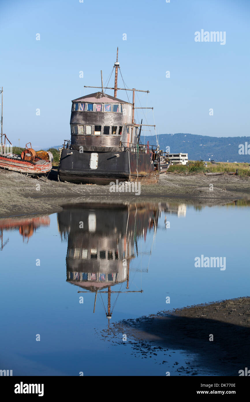 A shipwreck at a junkyard on The Spit in Homer, Alaska, USA Stock Photo